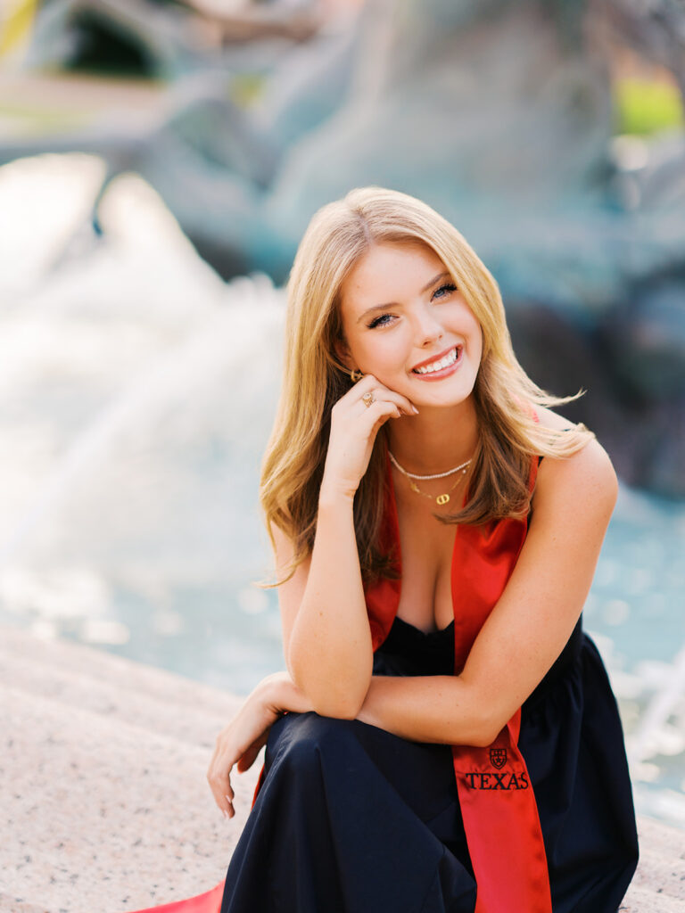 UT Austin grad photos at Littlefield Fountain during golden hour, capturing joyful senior portraits full of color and celebration.