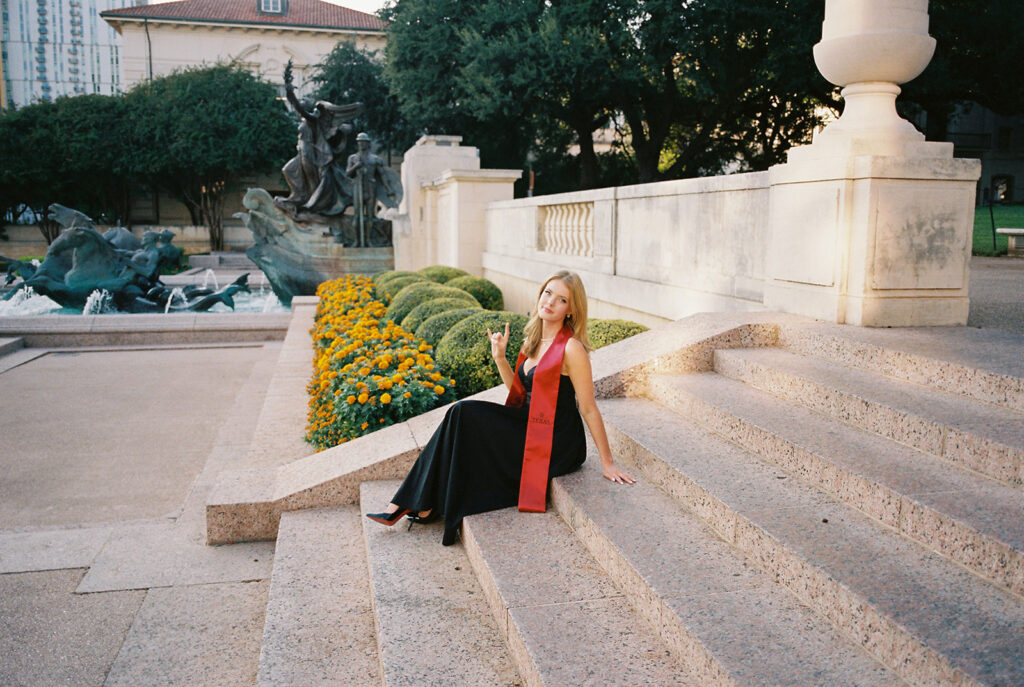 University of Texas grad photos around the UT Austin campus, capturing timeless senior portraits filled with light, laughter, and celebration on film
