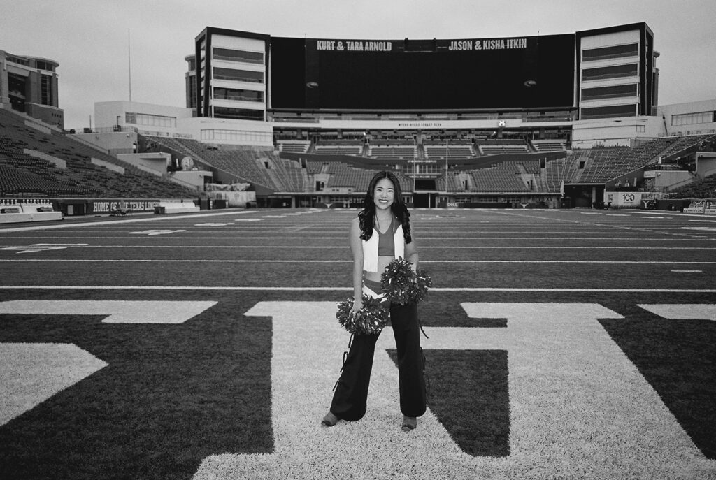 University of Texas senior in Texas Pom uniform during DKR stadium graduation session on film