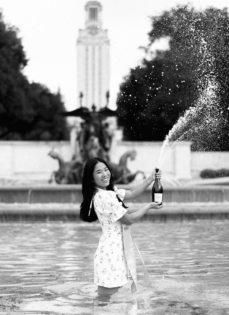 Champagne pop photo in the UT fountain during senior session