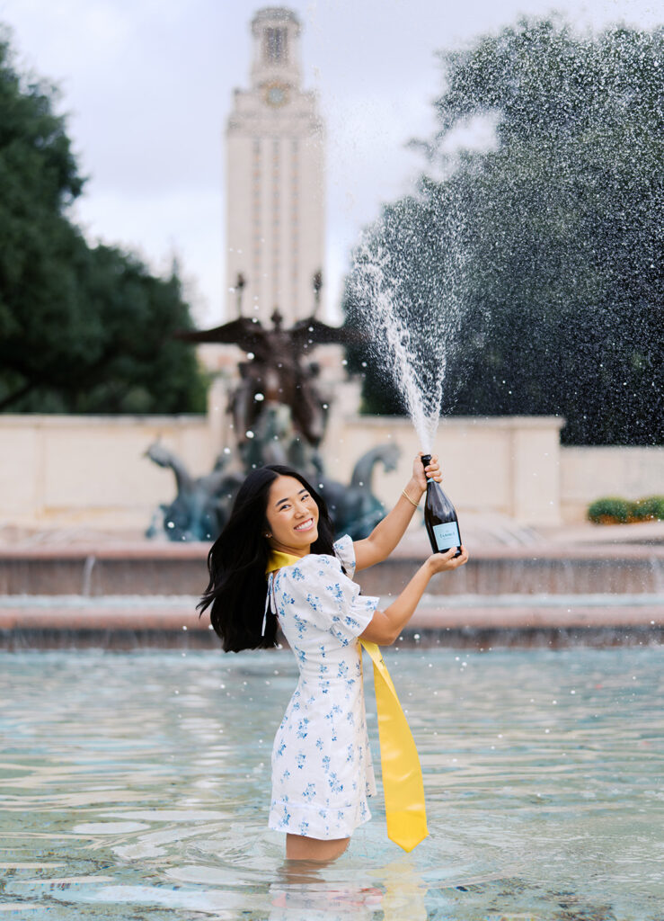 Champagne pop photo in the UT fountain during senior session