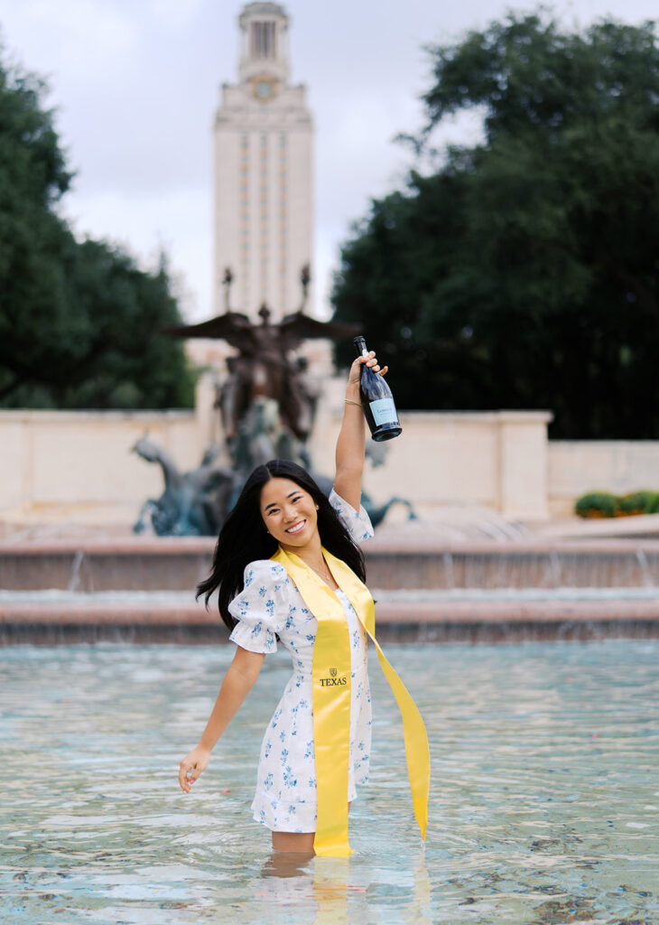 Champagne pop photo in the UT fountain during senior session