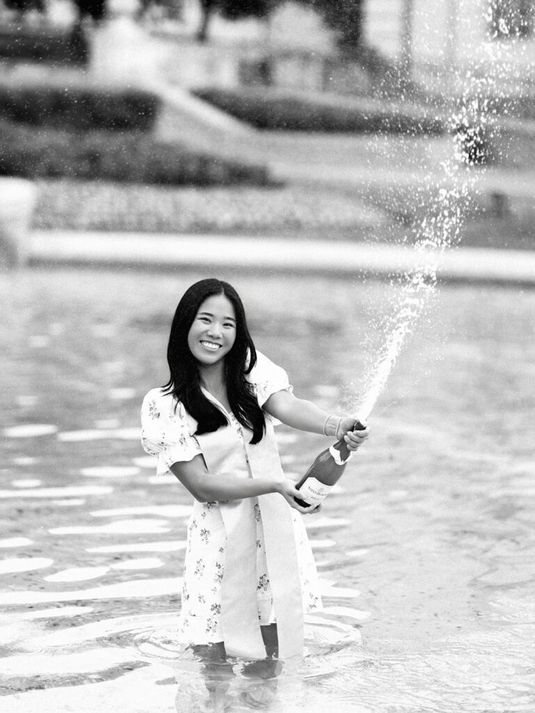 Champagne pop photo in the UT fountain during senior session