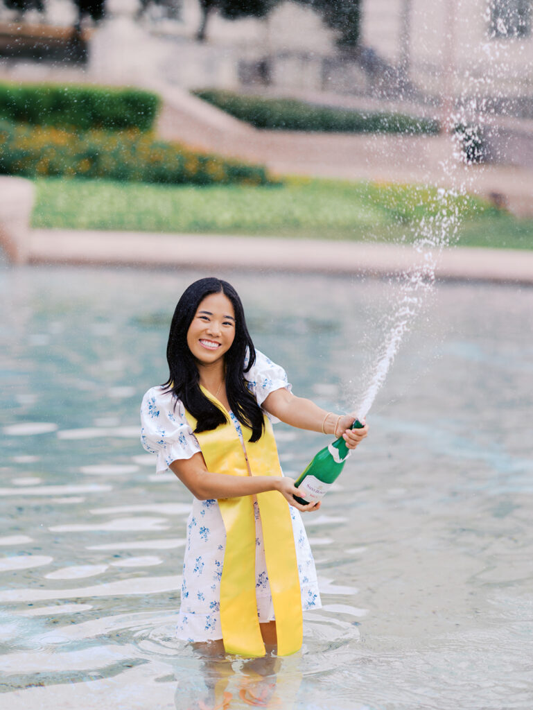 Champagne pop photo in the UT fountain during senior session