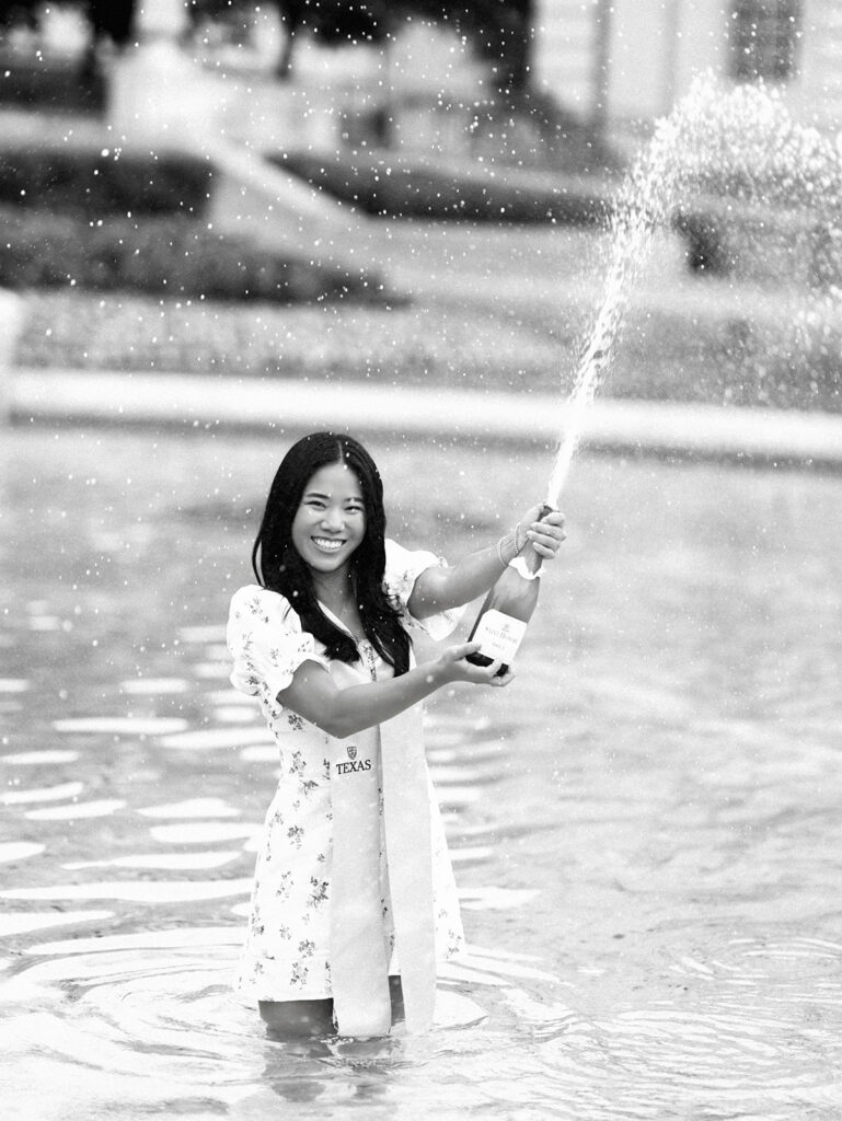 Champagne pop photo in the UT fountain during senior session