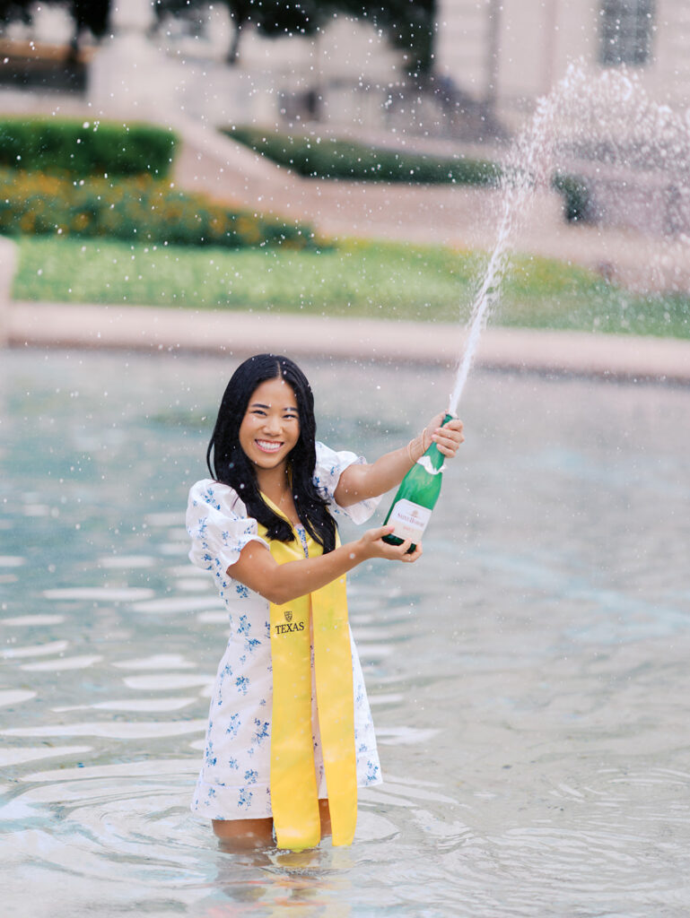 Champagne pop photo in the UT fountain during senior session