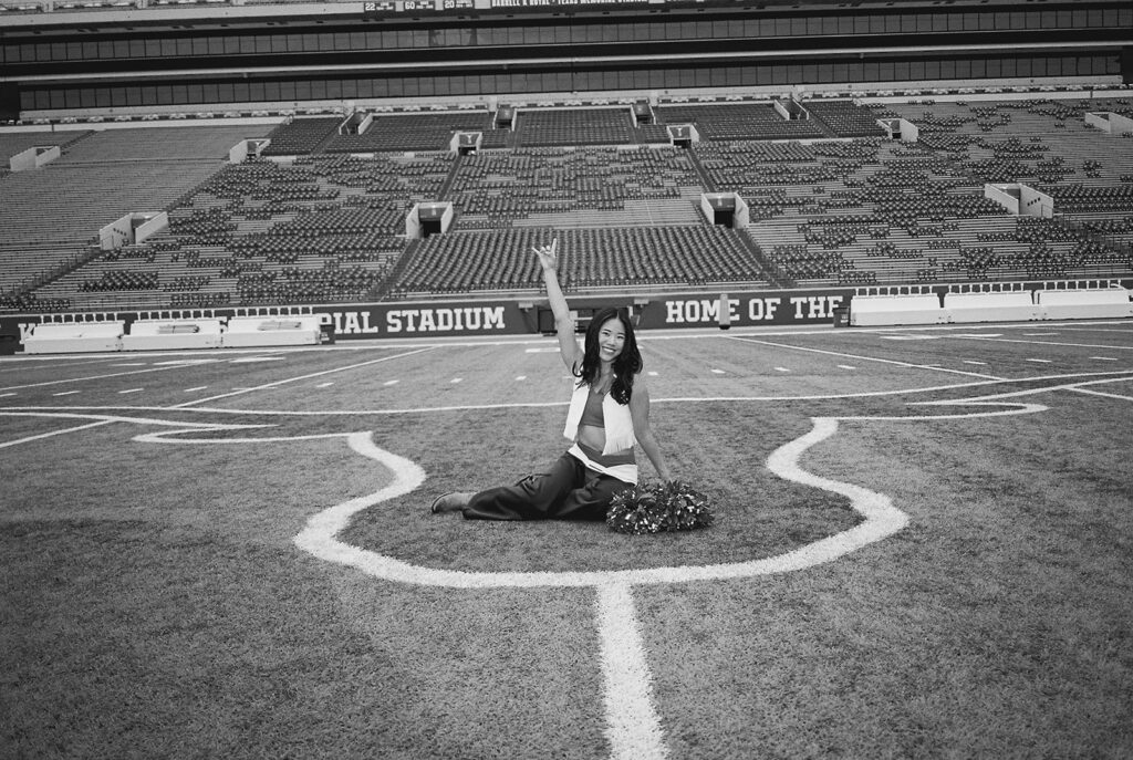 University of Texas senior in Texas Pom uniform during DKR stadium graduation session on film
