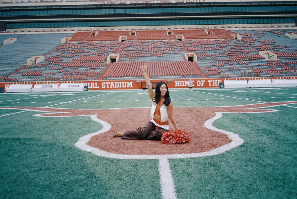 University of Texas senior in Texas Pom uniform during DKR stadium graduation session on film