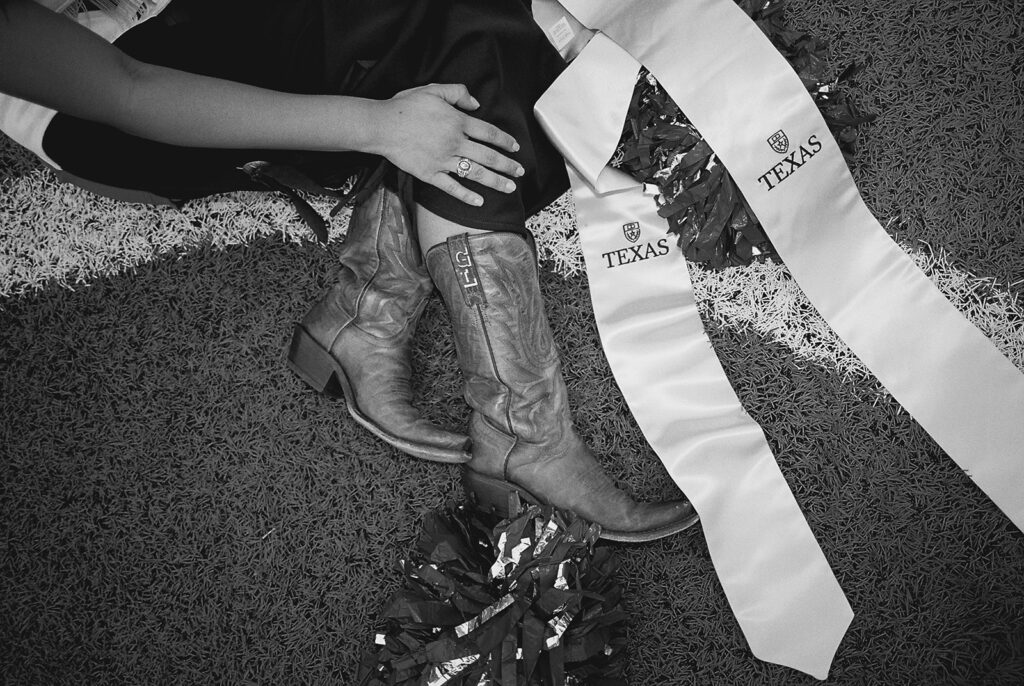 University of Texas senior in Texas Pom uniform during DKR stadium graduation session on film