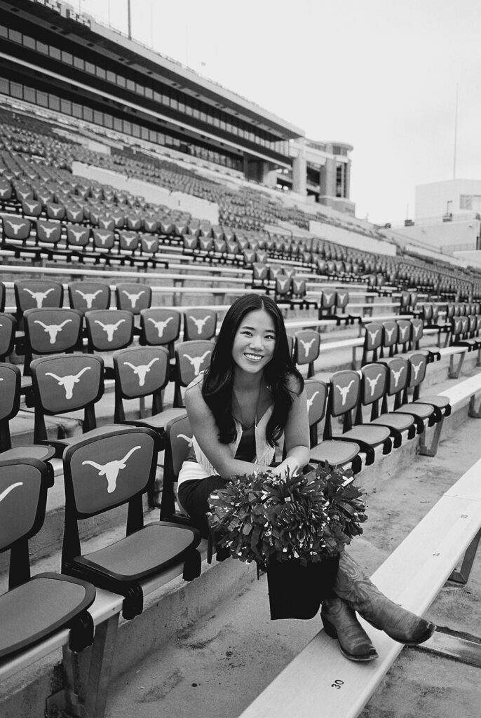 University of Texas senior in Texas Pom uniform during DKR stadium graduation session on film
