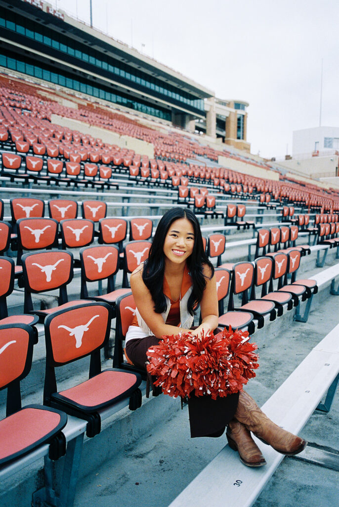 University of Texas senior in Texas Pom uniform during DKR stadium graduation session on film