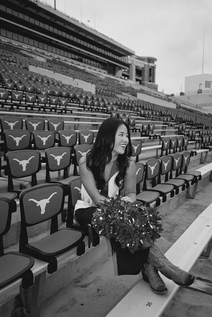University of Texas senior in Texas Pom uniform during DKR stadium graduation session on film