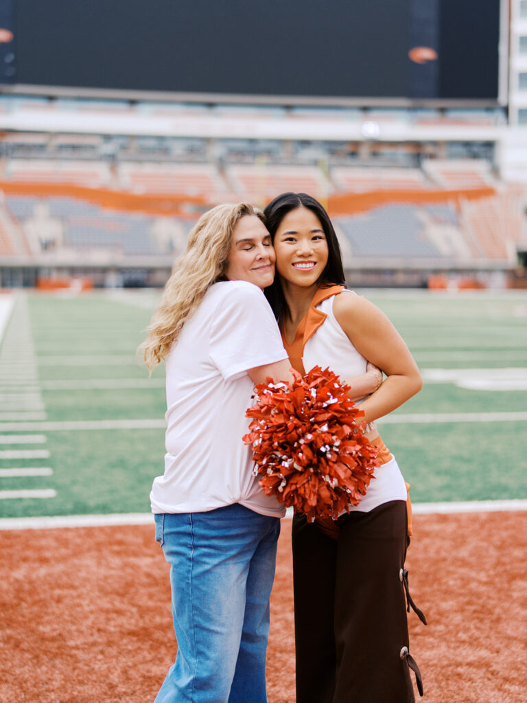 University of Texas senior in Texas Pom uniform during DKR stadium graduation session on film