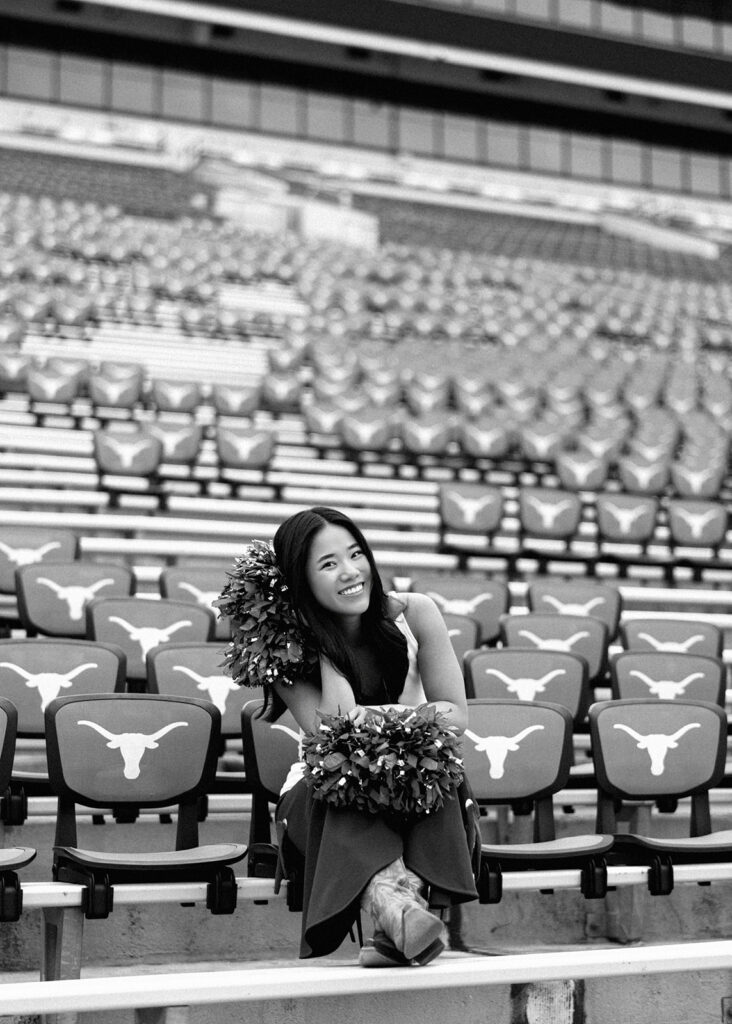 University of Texas senior in Texas Pom uniform during DKR stadium graduation session on film