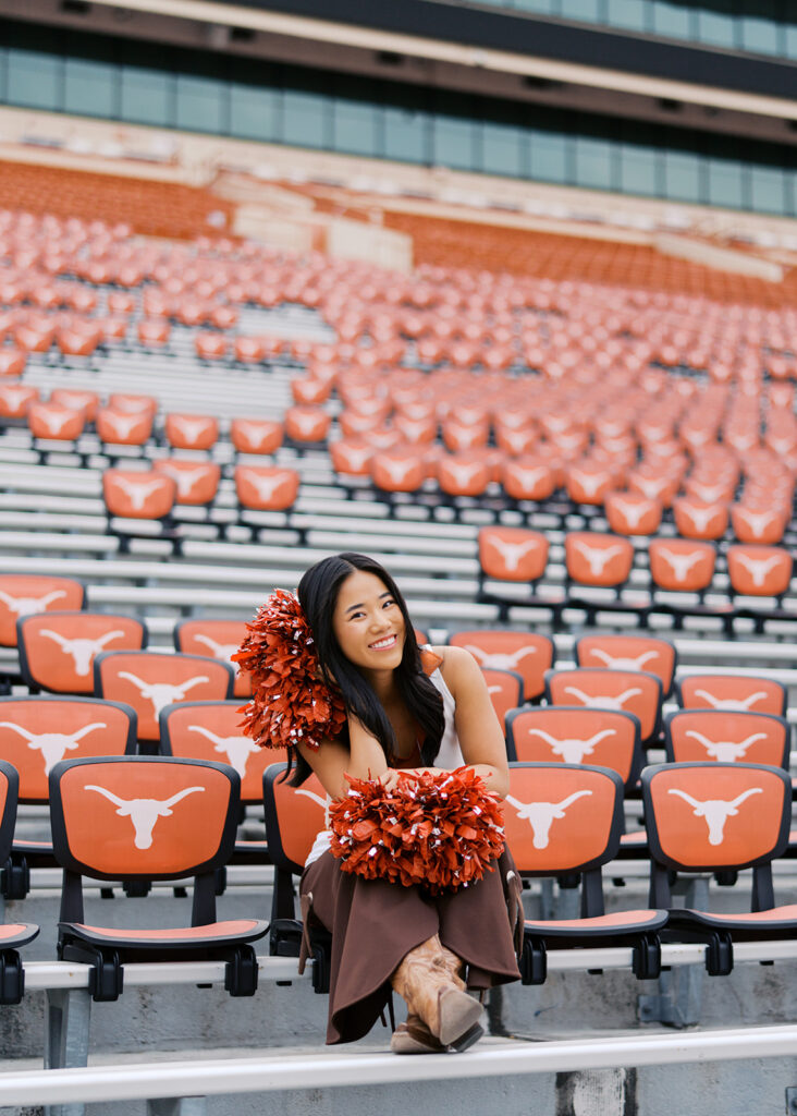 University of Texas senior in Texas Pom uniform during DKR stadium graduation session on film