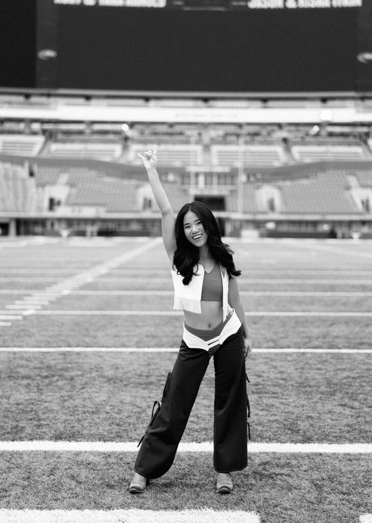 University of Texas senior in Texas Pom uniform during DKR stadium graduation session