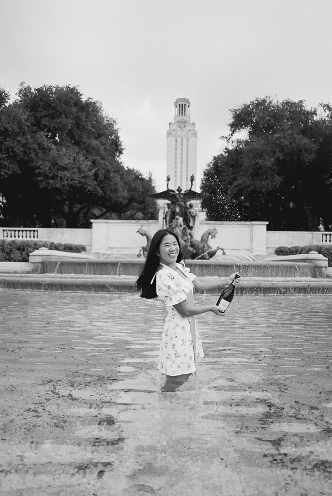 Champagne pop photo in the UT fountain during senior session on film