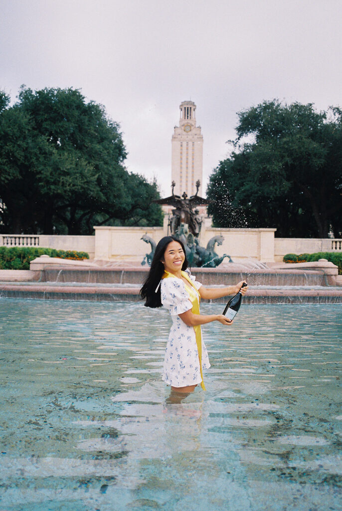 Champagne pop photo in the UT fountain during senior session on film