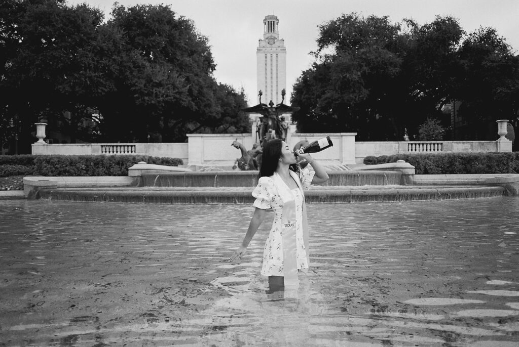 Champagne pop photo in the UT fountain during senior session on film