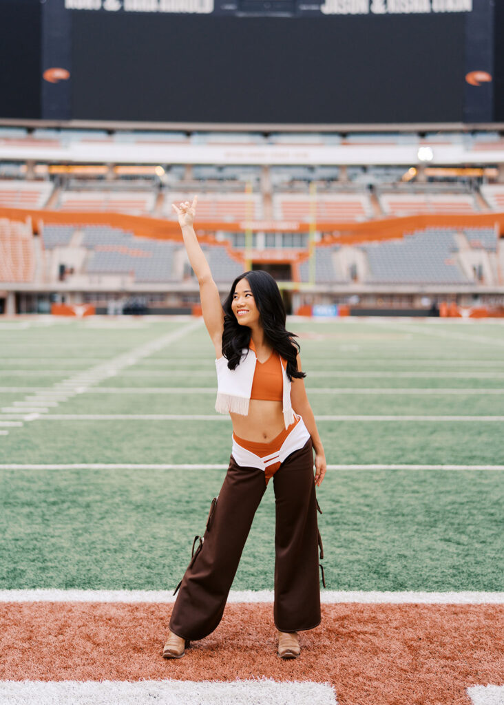 University of Texas senior in Texas Pom uniform during DKR stadium graduation session