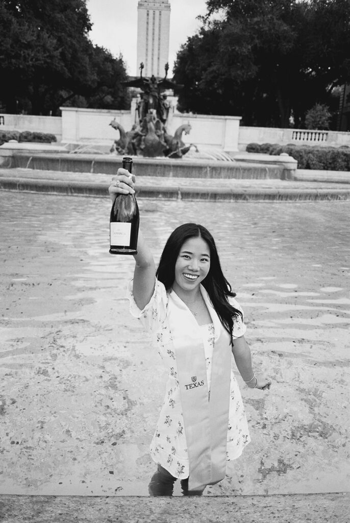 Champagne pop photo in the UT fountain during senior session on film