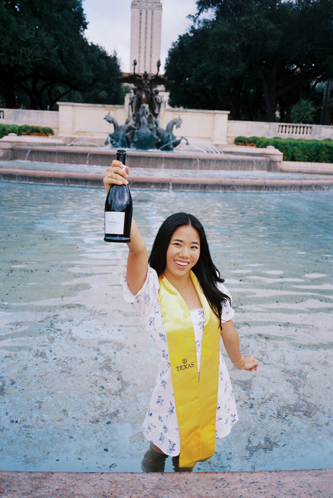 Champagne pop photo in the UT fountain during senior session on film