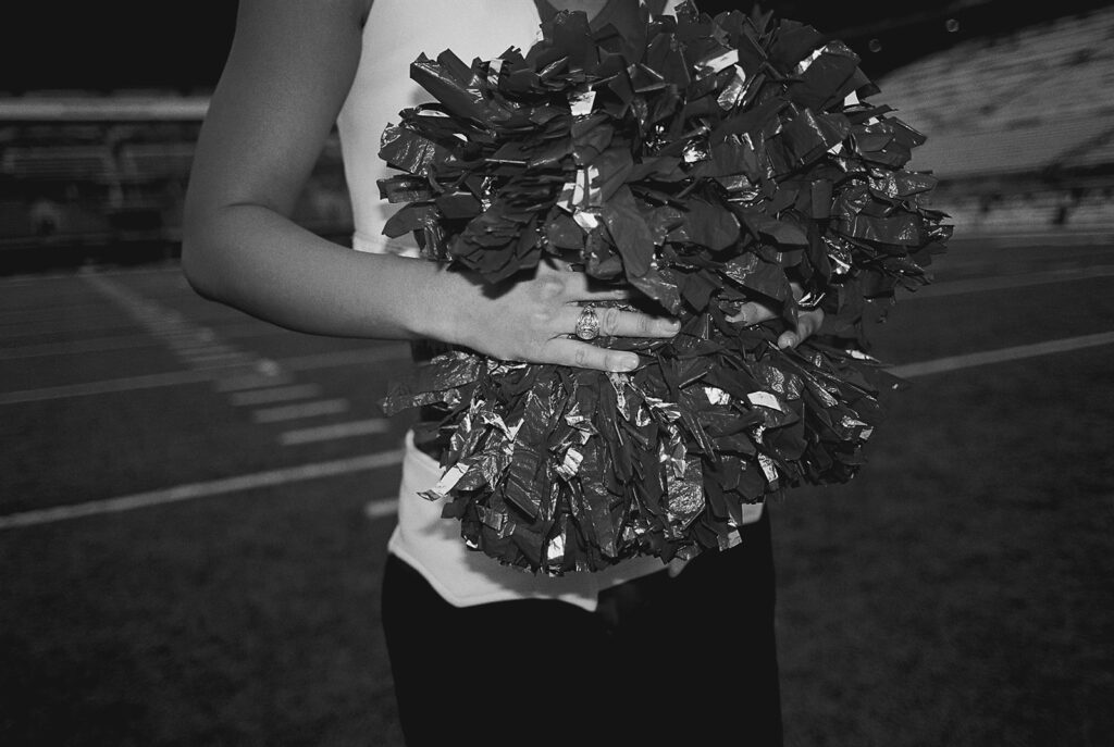 University of Texas senior in Texas Pom uniform during DKR stadium graduation session on film