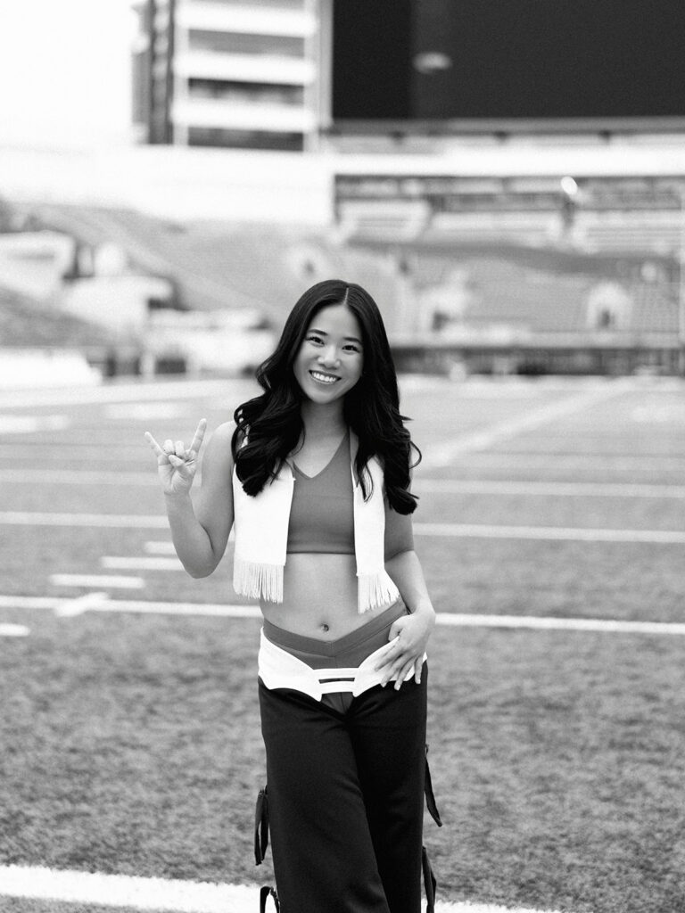 University of Texas senior in Texas Pom uniform during DKR stadium graduation session