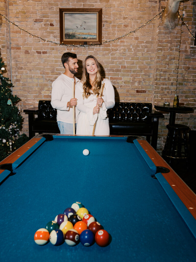 Chris and Reagan laughing at the bar during their Seven Grand Austin engagement session