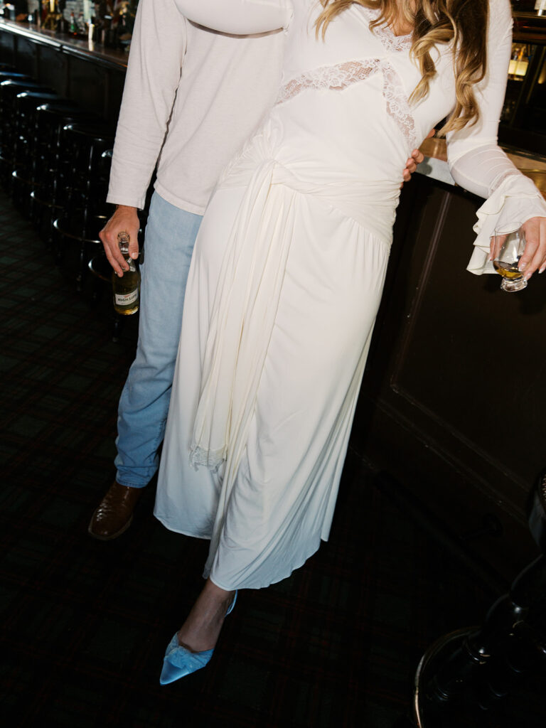 Chris and Reagan laughing at the bar during their Seven Grand Austin engagement session