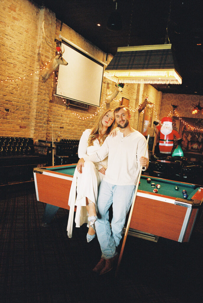 Chris and Reagan enjoying an indoor engagement session at Seven Grand Austin