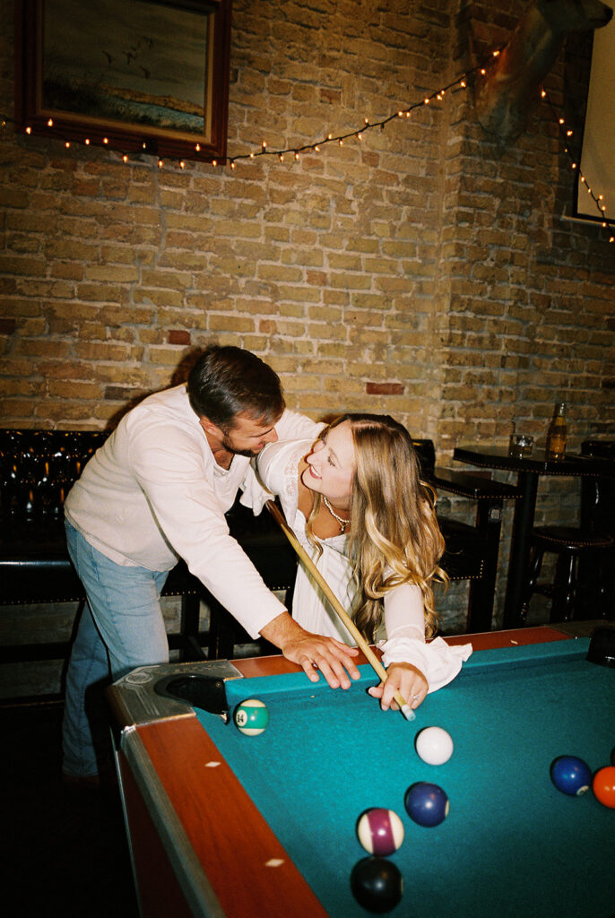 Chris and Reagan enjoying an indoor engagement session at Seven Grand Austin