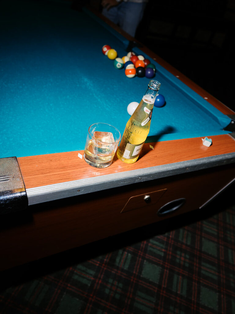 Film photography engagement session in a dark and moody Austin bar