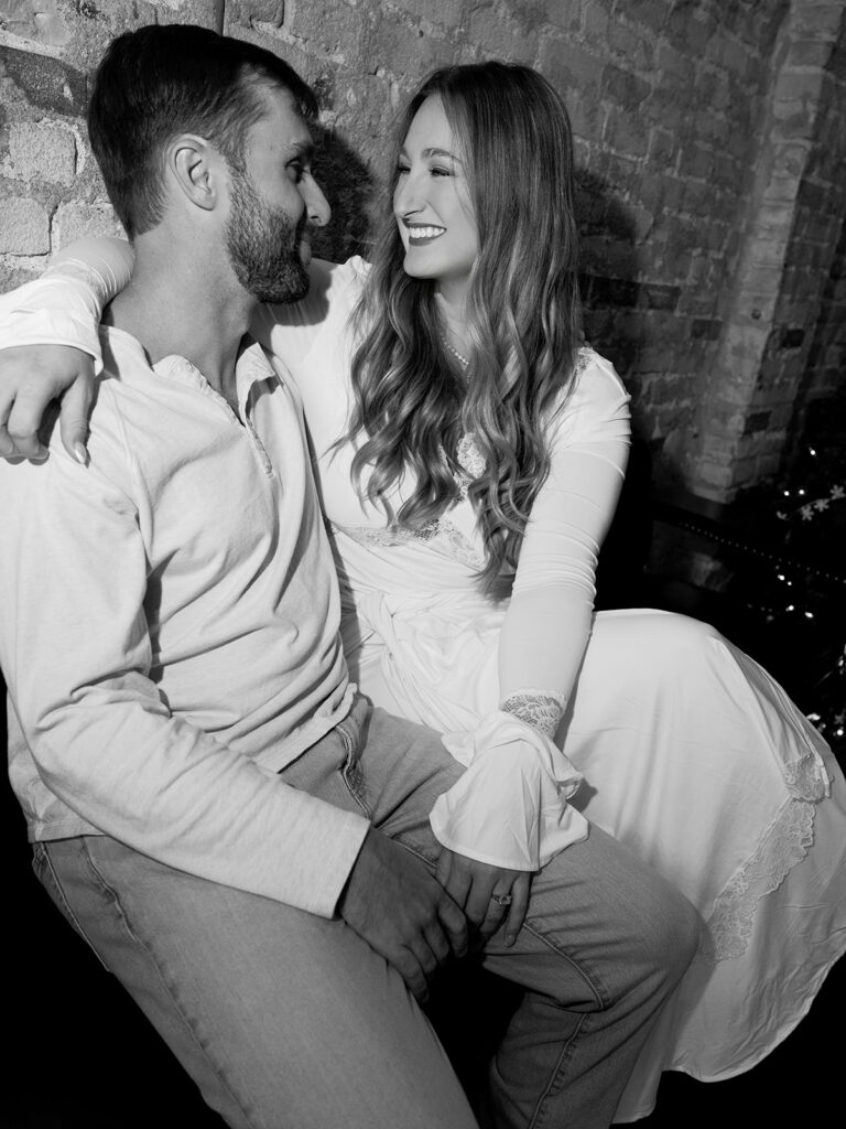 Chris and Reagan laughing at the bar during their Seven Grand Austin engagement session
