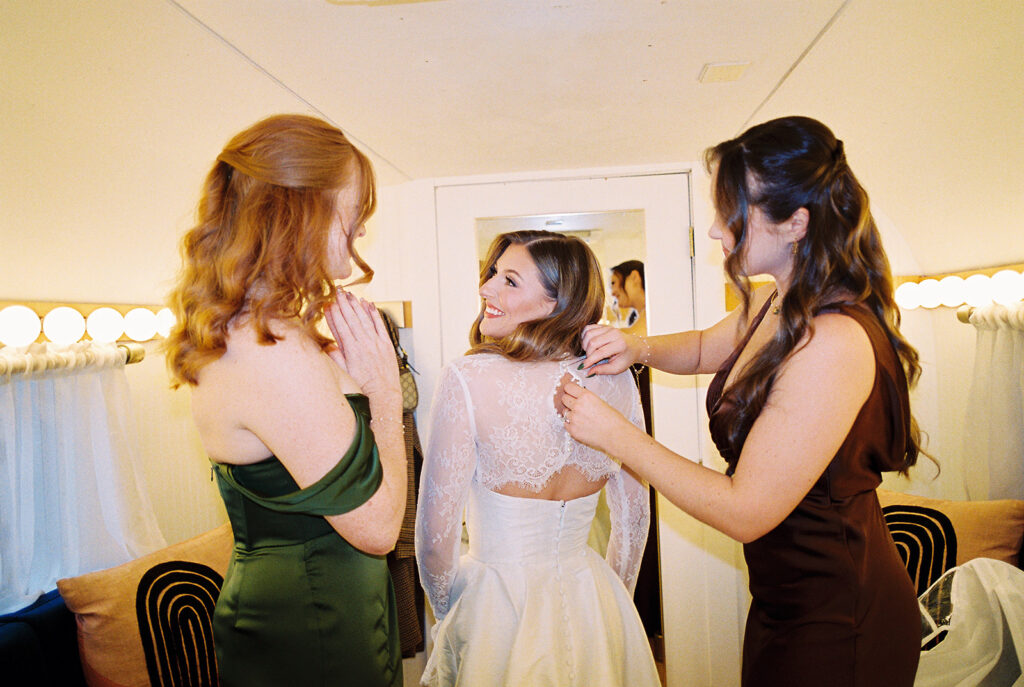 bride and groom getting ready for an Intimate wedding at Springdale Station in Austin, Texas photographed on film