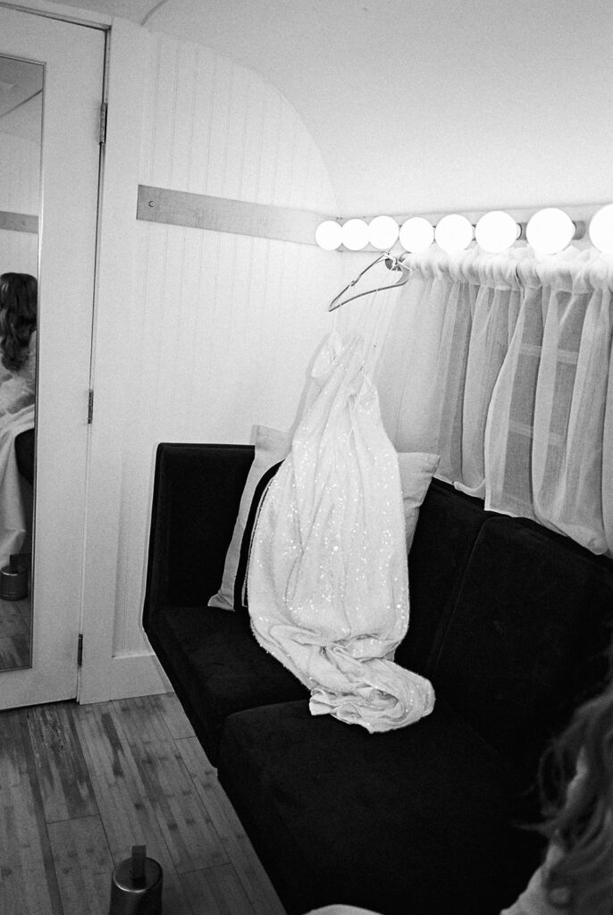 bride and groom getting ready for an Intimate wedding at Springdale Station in Austin, Texas photographed on film