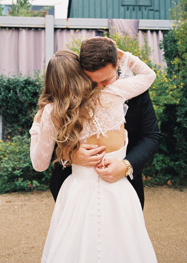 Emotional first look during an intimate wedding in Austin, Texas photographed on film