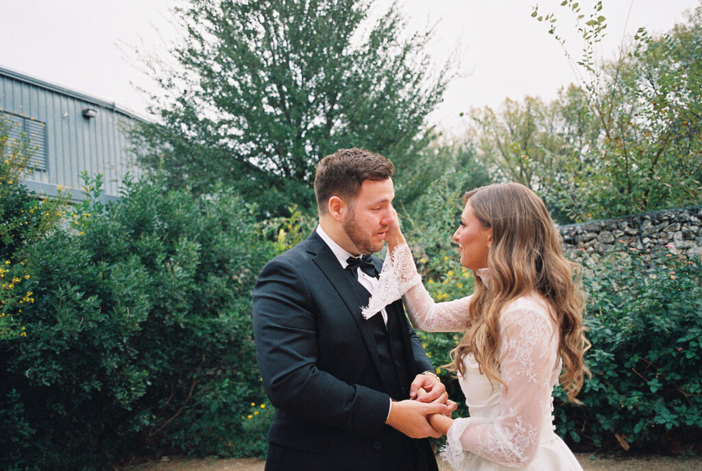 Emotional first look during an intimate wedding in Austin, Texas photographed on film