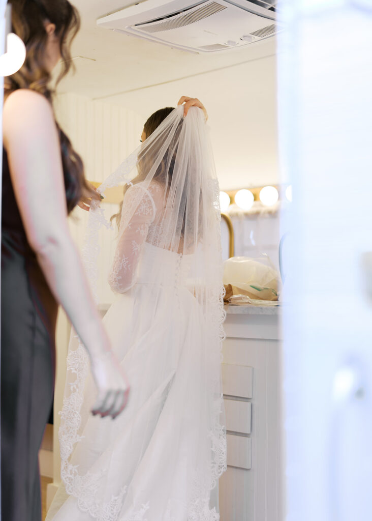 bride and groom getting ready for an Intimate wedding at Springdale Station in Austin, Texas photographed on film