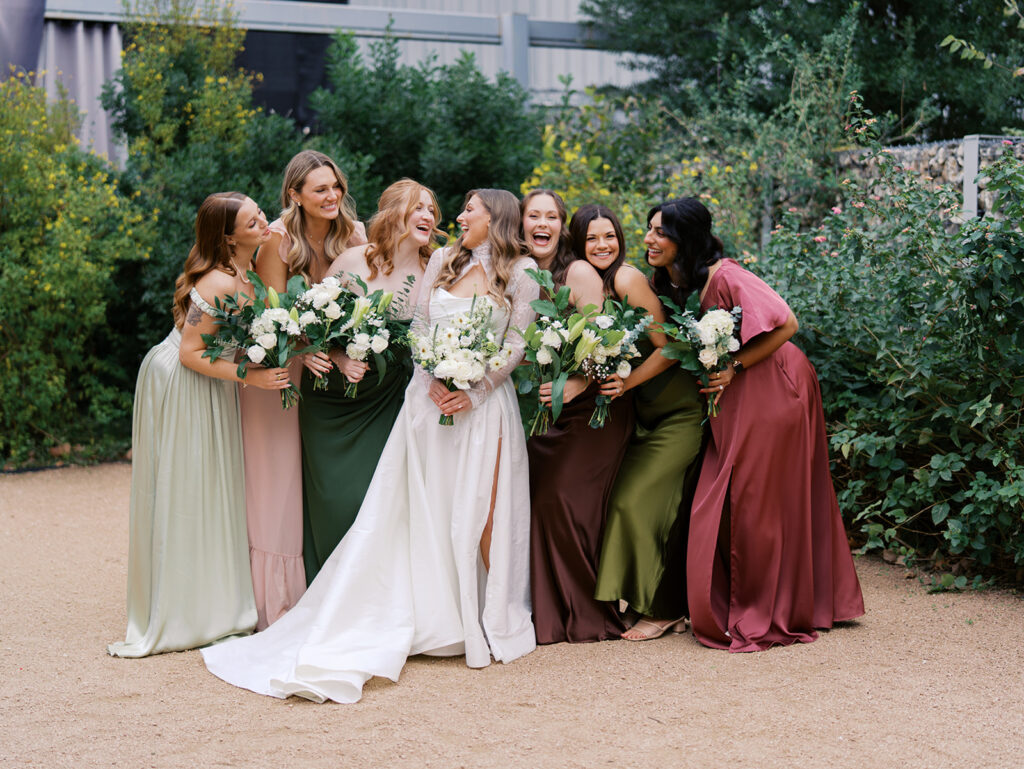 Bride and bridesmaids portrait outdoors at Springdale Station wedding venue