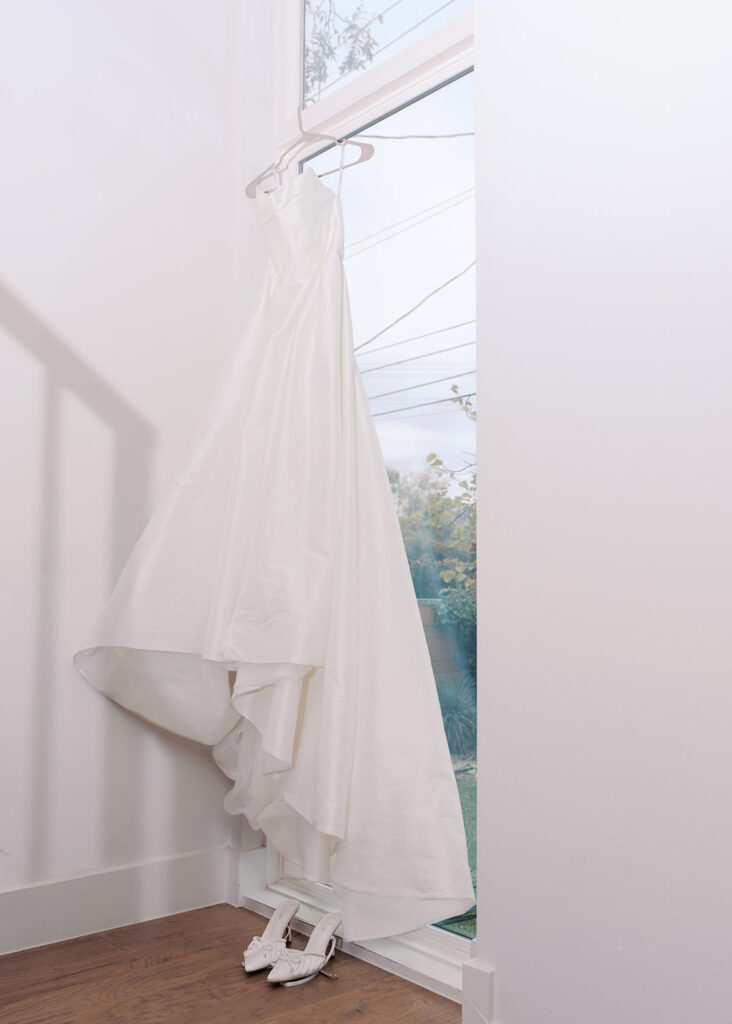 bride and groom getting ready for an Intimate wedding at Springdale Station in Austin, Texas photographed on film