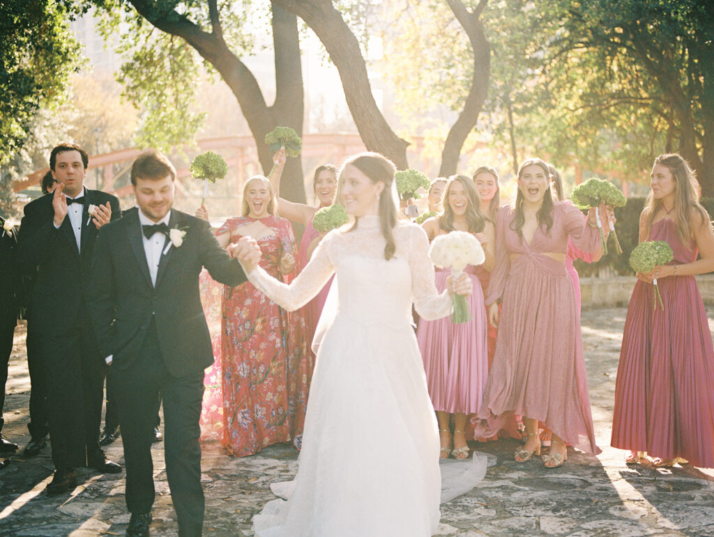 Joyful wedding party and newlyweds celebrating their Southwest School of Art wedding in San Antonio