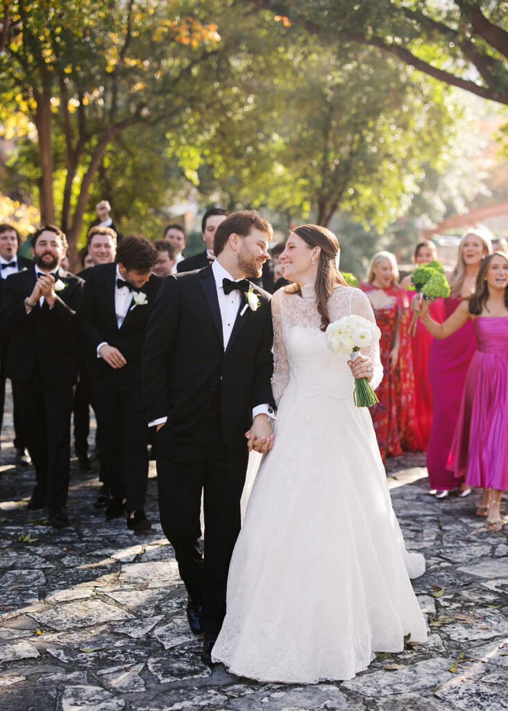 Joyful wedding party and newlyweds celebrating their Southwest School of Art wedding in San Antonio