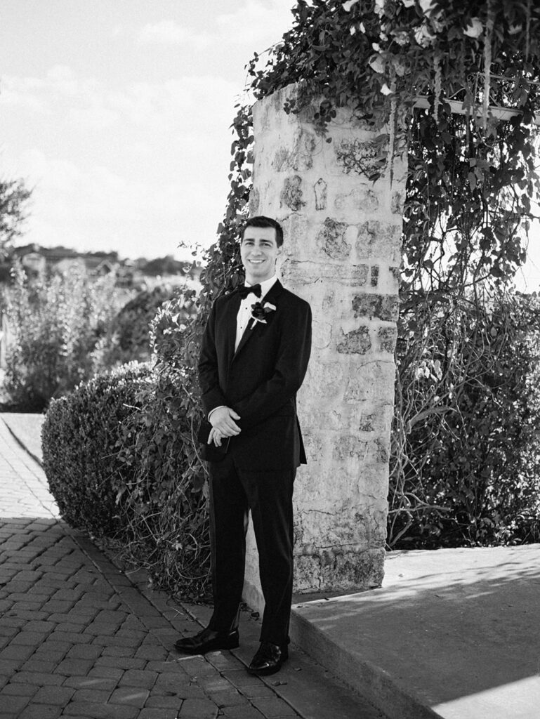 Groom adjusting tie before first look on winter wedding day