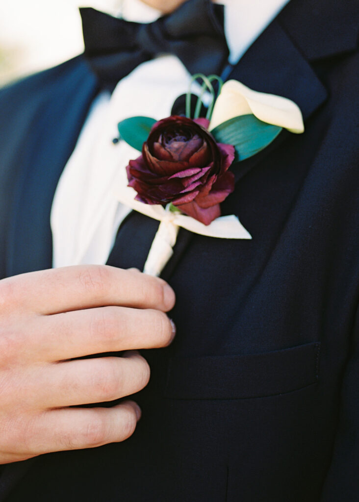 Groom adjusting tie before first look on winter wedding day