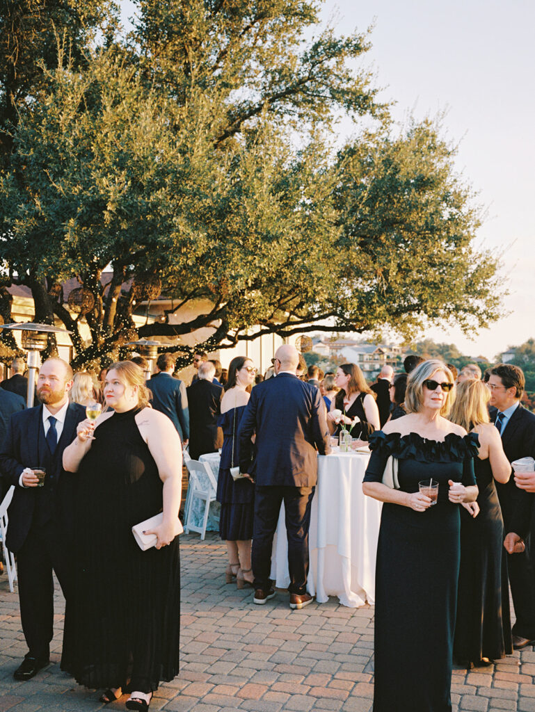 Guests mingling during outdoor cocktail hour at Vintage Villas, captured on 35mm film