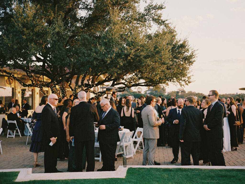 Guests mingling during outdoor cocktail hour at Vintage Villas, captured on 35mm film