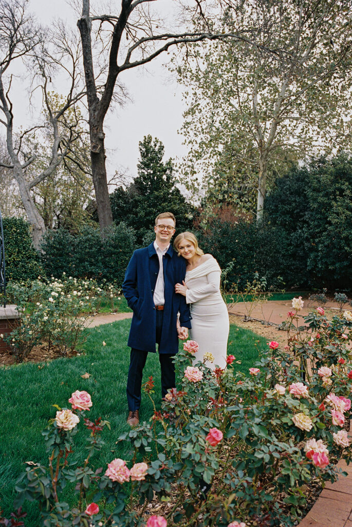 Sierra and Liam walking together during their Dallas Arboretum engagement photos