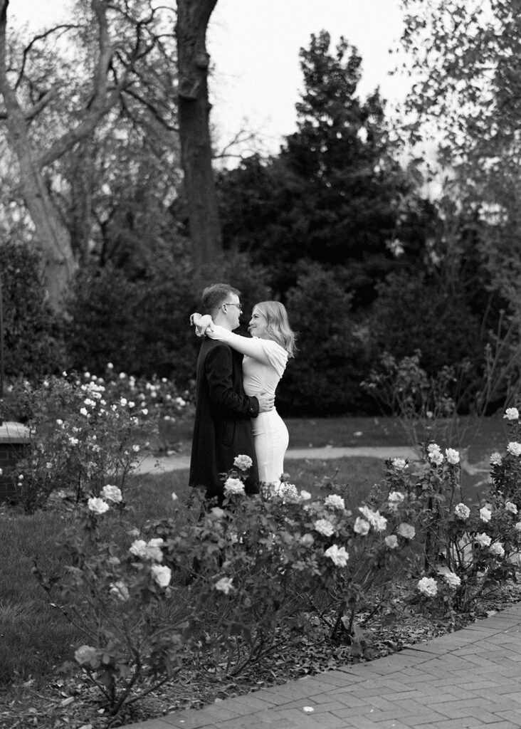 Sierra and Liam walking together during their Dallas Arboretum engagement photos