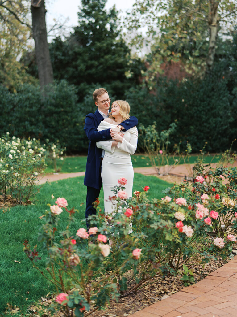Sierra and Liam walking together during their Dallas Arboretum engagement photos
